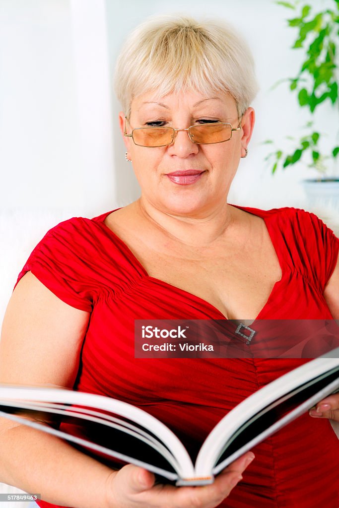 Senior woman reading Senior woman reading a book 50-59 Years Stock Photo