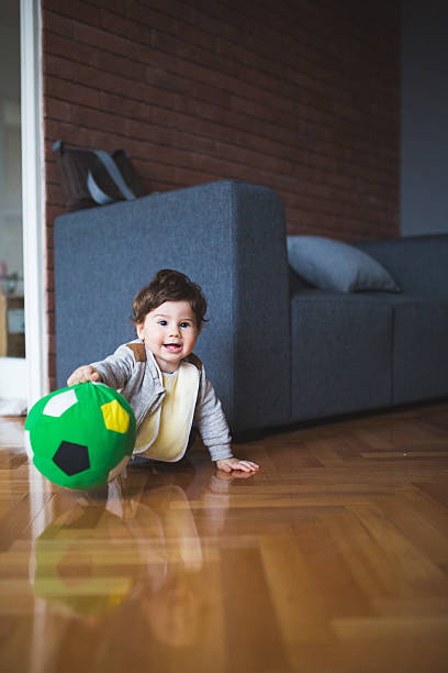 istock Little boy playing with green ball 517849738