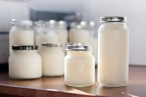 Frozen mother milk in bottles Storing breast milk. Frozen breast milk in  bottles of glasses just taken out of the freezer. breast milk stock pictures, royalty-free photos & images