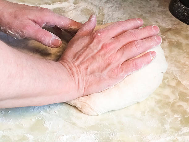 istock Female Hands Kneading Sourdough Bread 517850422