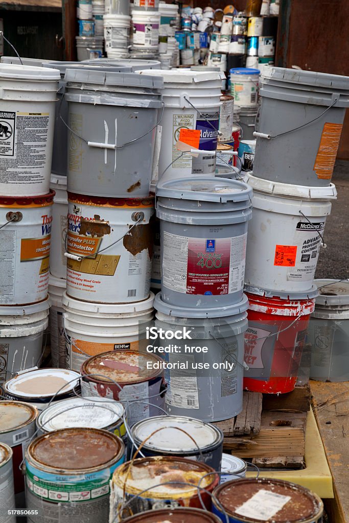 Paint dumpster Fairfax, VA, USA - December 5, 2013: Paint cans gathered in order to be recycled. They will be sorted out and the latex ones will be separated from the oil cans. Unlike oil paints, latex paints aren't considered hazardous waste and can be recycled with metals. The oil cans will be brought to an household hazardous waste facility. Paint Stock Photo