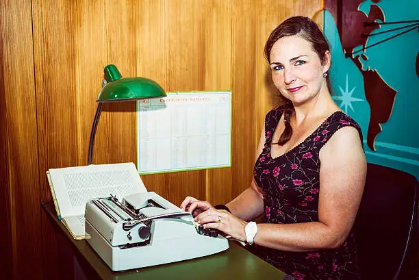 Secretary in a sixties style office, with old typewriter.