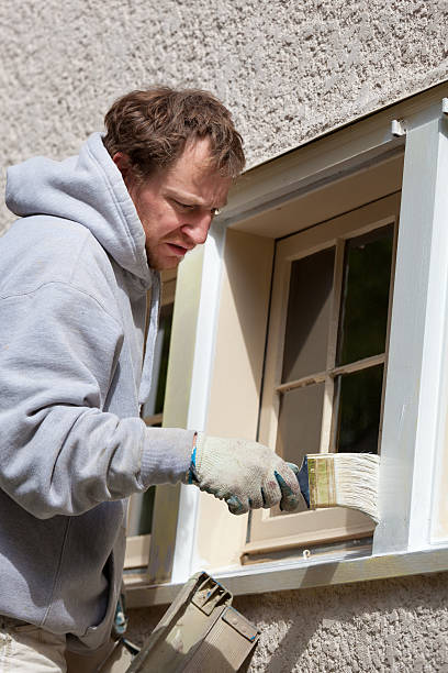 istock House Painter Working on Exterior Home Maintenance Improvement Painting Work 517851306