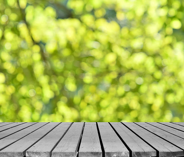 istock Green spring defocused abstract background and empty wooden platform 517852594