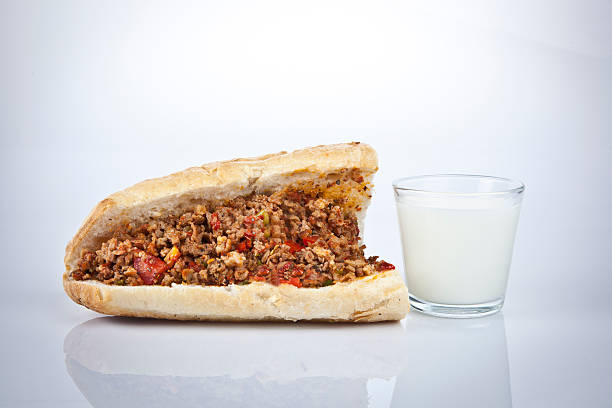 Turkish Kokorec - lamb intestine food sandwich with midye ayran stock photo