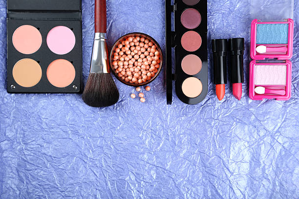 istock Makeup brush and cosmetics on a blue background 517852876