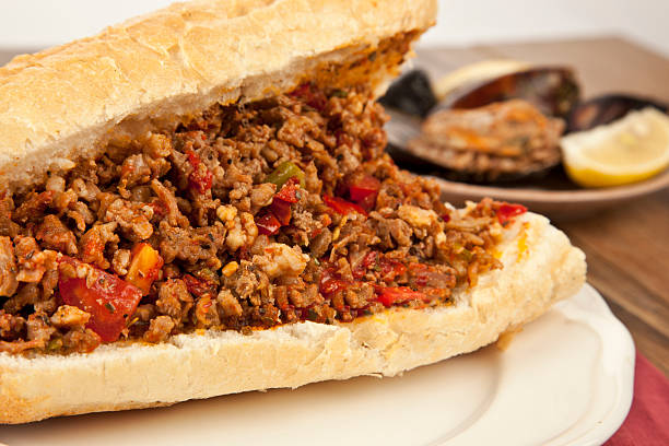 Turkish Kokorec - lamb intestine food sandwich with midye dolma stock photo