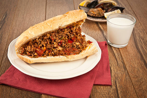 Turkish Kokorec - lamb intestine food sandwich with midye dolma stock photo