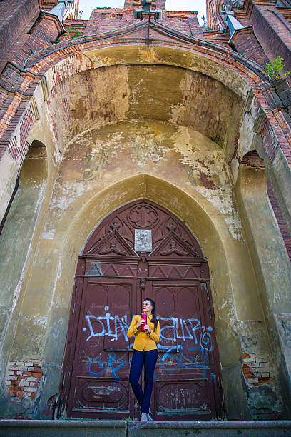 istock Girl posing in an old cathedral 517854487