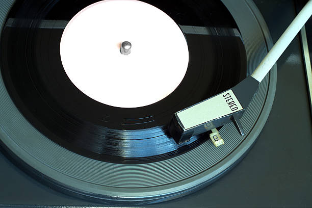 istock Vintage turntable with vinyl record top view closeup 517864290