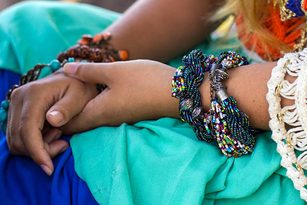 istock Female hands with bright bracelets,  blue orange dress 517864408