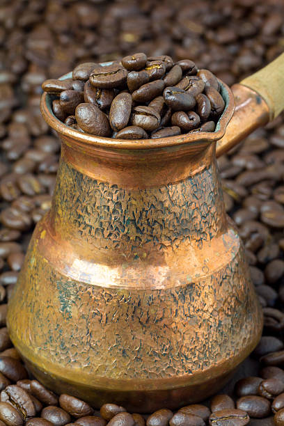 istock Fragrant coffee beans in copper cezve, close up 517864804