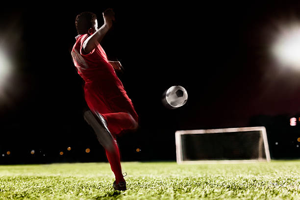 istock Soccer player kicking soccer ball 517866206