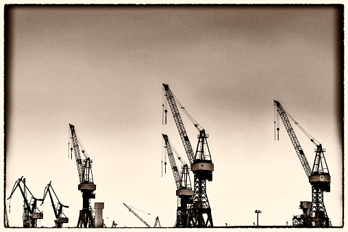 some big cranes at the harbor of Hamburg in Germany - vintage style