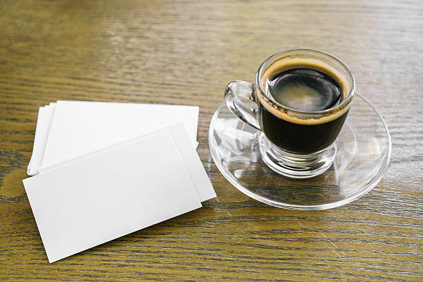 istock Business cards on wood table with coffee 517869376