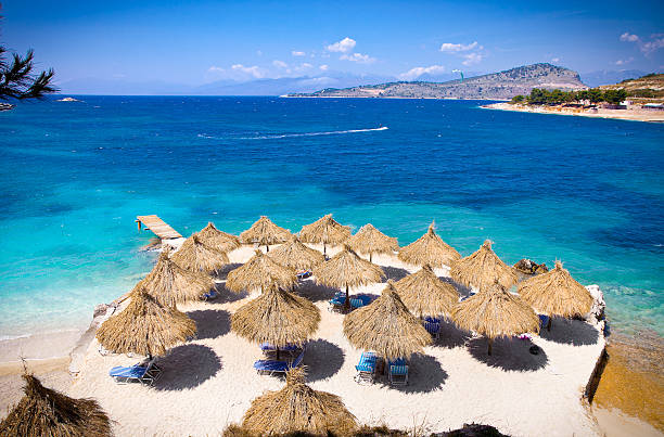 Sunshade umbrellas and deckchairs on the beautiful Ksamil beach, Albania.