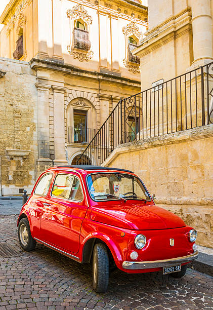 Red Fiat in Italy Noto, Italy - March 17, 2016: A classic old Fiat 500 car parked on a street in Noto, Sicily, Italy. noto sicily stock pictures, royalty-free photos & images