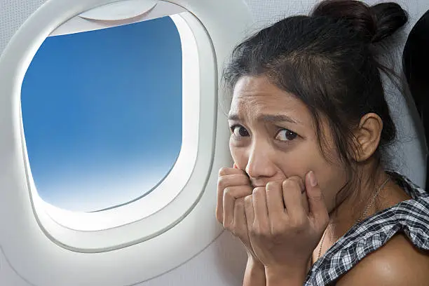 Photo of terrified passenger on a plane