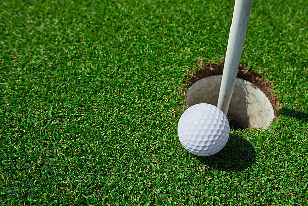 istock golf ball near hole 517870000