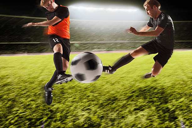 istock Two soccer players kicking a soccer ball 517870592