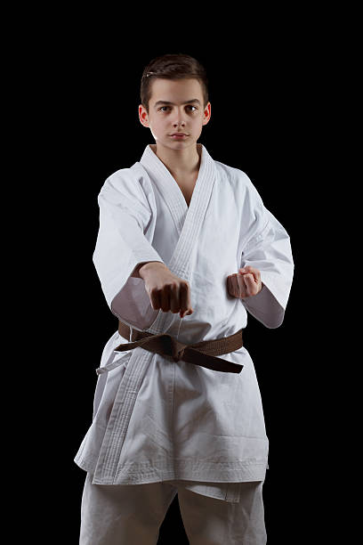 istock Karate Fighter in white Kimono Isolated on Black 517871278