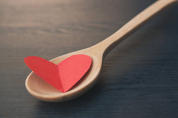 istock Concept, A heart is in a wooden spoon 517871322