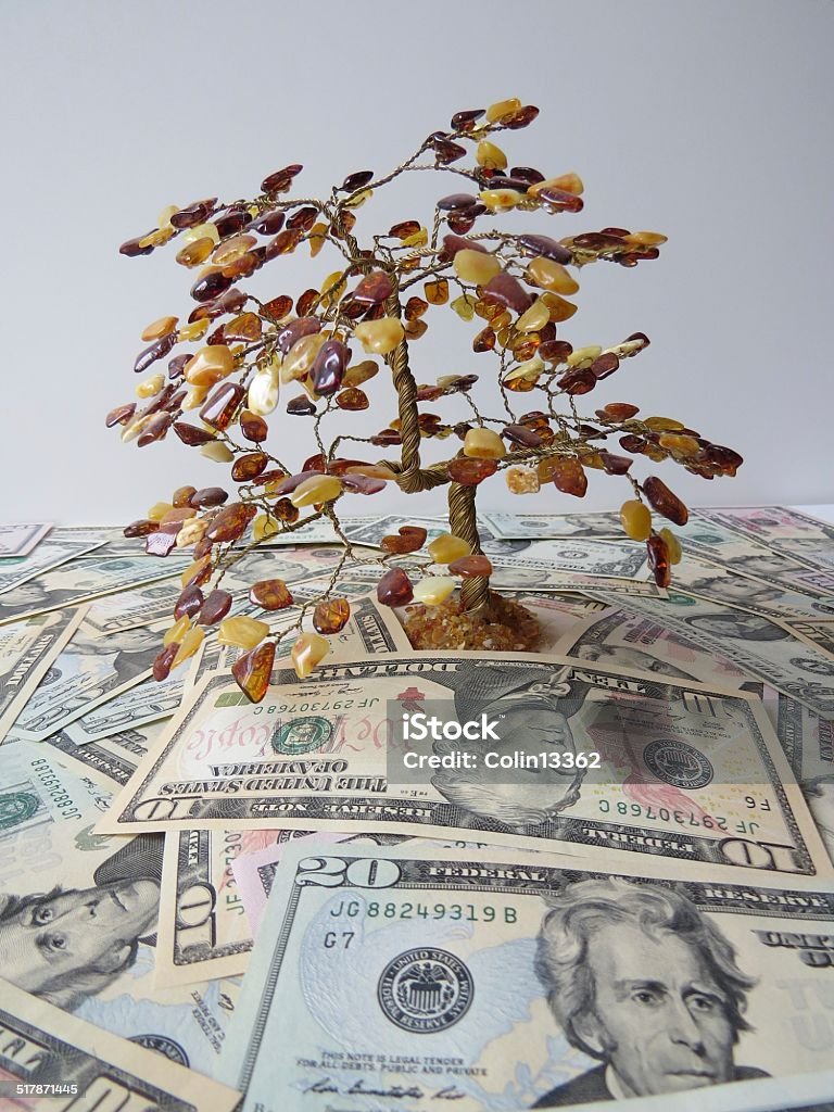 money tree amber tree surrounded by American banknotes Currency Stock Photo