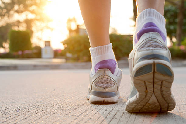istock Runner feet running on road closeup on shoe. 517871492