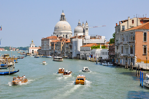 Venice, Italy - July 23, 2010: The Grand Canal in Venice with boats on the canal, tourists enjoy sightseeing. 
