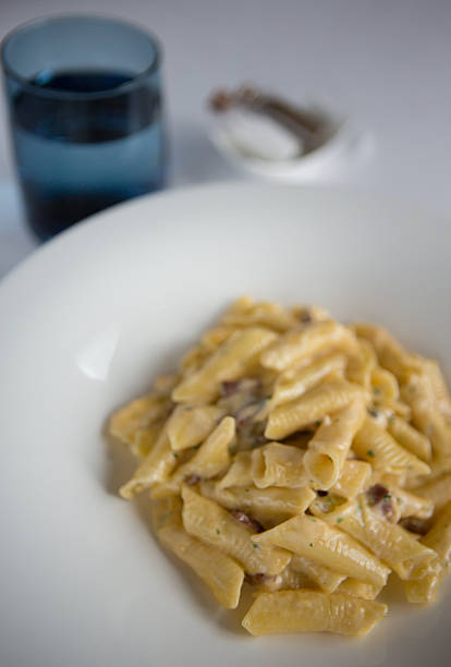 istock Garganelli pasta Carbonara served in a white bowl. 517872292