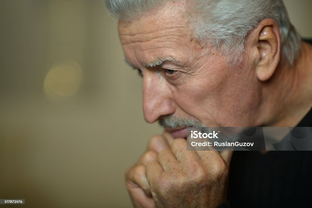 Sad senior man at home Portrait of Sad senior man at home Adult Stock Photo