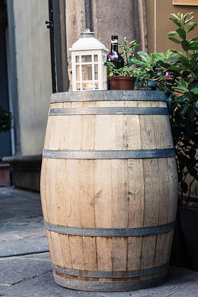 Lantern with a candle inside on a wood barrel