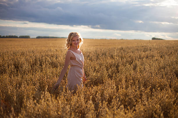 istock young woman in wheat field 517873127