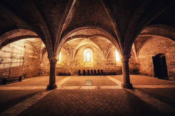 Sacred Place Illuminated sacred place in an old abbey (San Galgano, Tuscany). cloister stock pictures, royalty-free photos & images