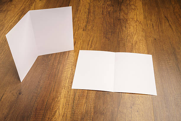 istock Bifold white template paper on wood texture 517875240