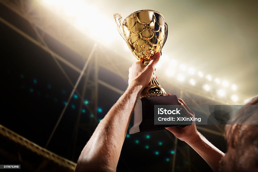Athlete holding trophy cup Soccer Stock Photo