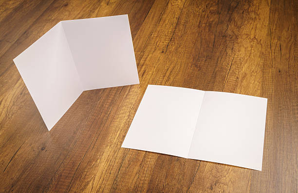 istock Bifold white template paper on wood texture 517875408
