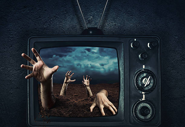 istock Zombie hand coming out of TV 517876063