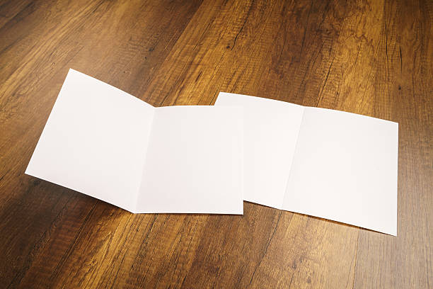 istock Bifold white template paper on wood texture 517876066