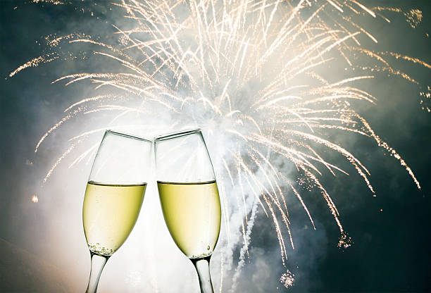 istock Glasses with champagne against holiday lights 517876163
