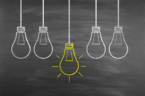 istock Concept of ideas, light bulbs on the chalkboard 517876328