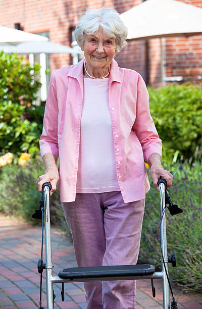 istock Elderly lady using a walker in the garden. 517876697