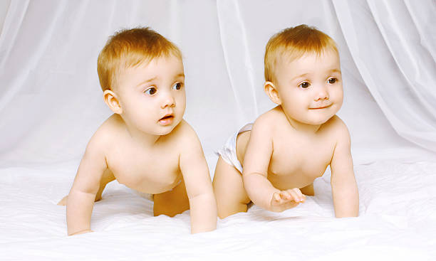 istock Cute twins baby on the bed 517876843