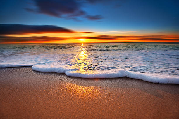istock Sunrise light shining on ocean waves. 517876940