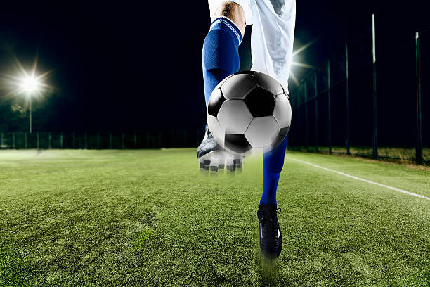istock Athlete kicking soccer ball 517877340