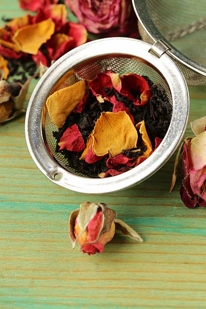 istock natural organic tea from dry roses on a wooden background 517877351