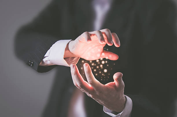 You have the power Concept - Businesssman using his inner power and concentrating glowing energy particles between his hands arise and shine stock pictures, royalty-free photos & images