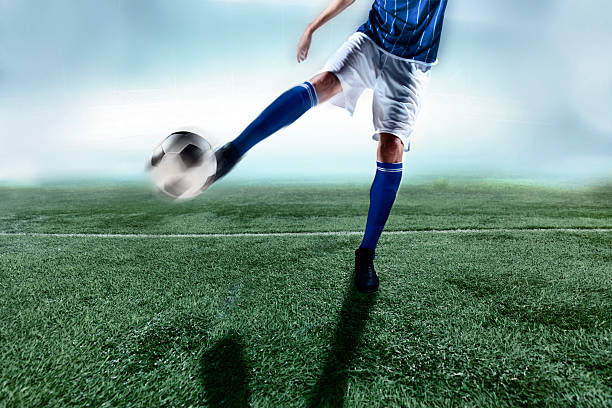istock Athlete kicking soccer ball 517877530