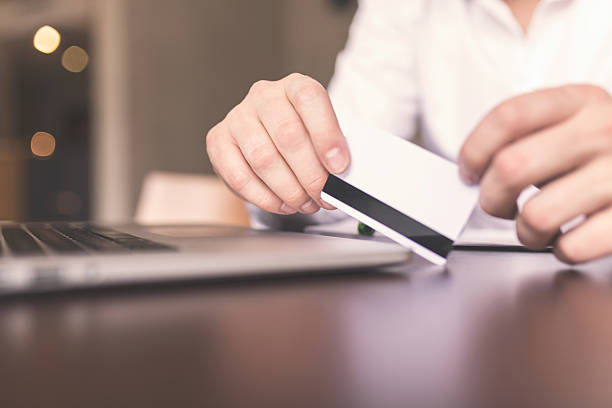 istock Close up of male hands making online payment 517877686