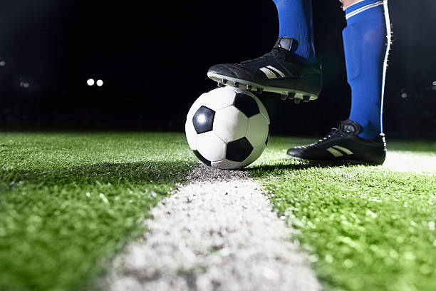 Foot on soccer ball stock photo